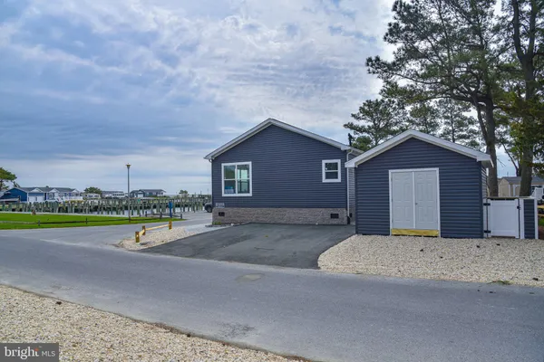 a view of a house with a big yard and potted plants