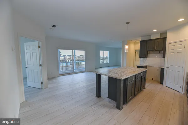 a kitchen with granite countertop a stove and a wooden floors