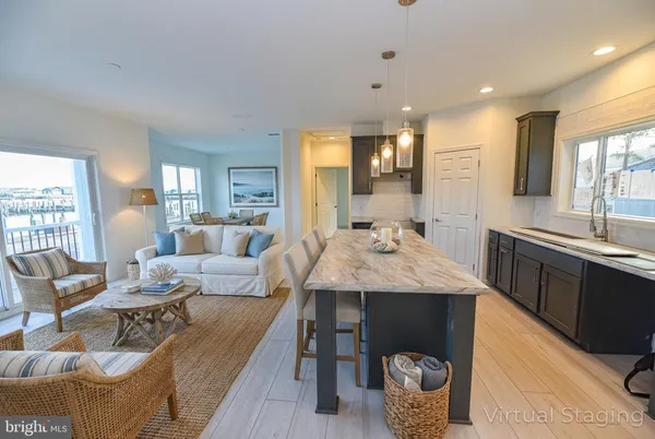 a living room with granite countertop kitchen island furniture and a view of kitchen