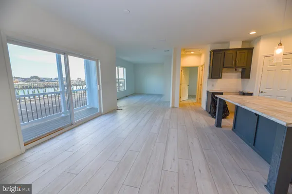 a view of a kitchen with wooden floor and a sink