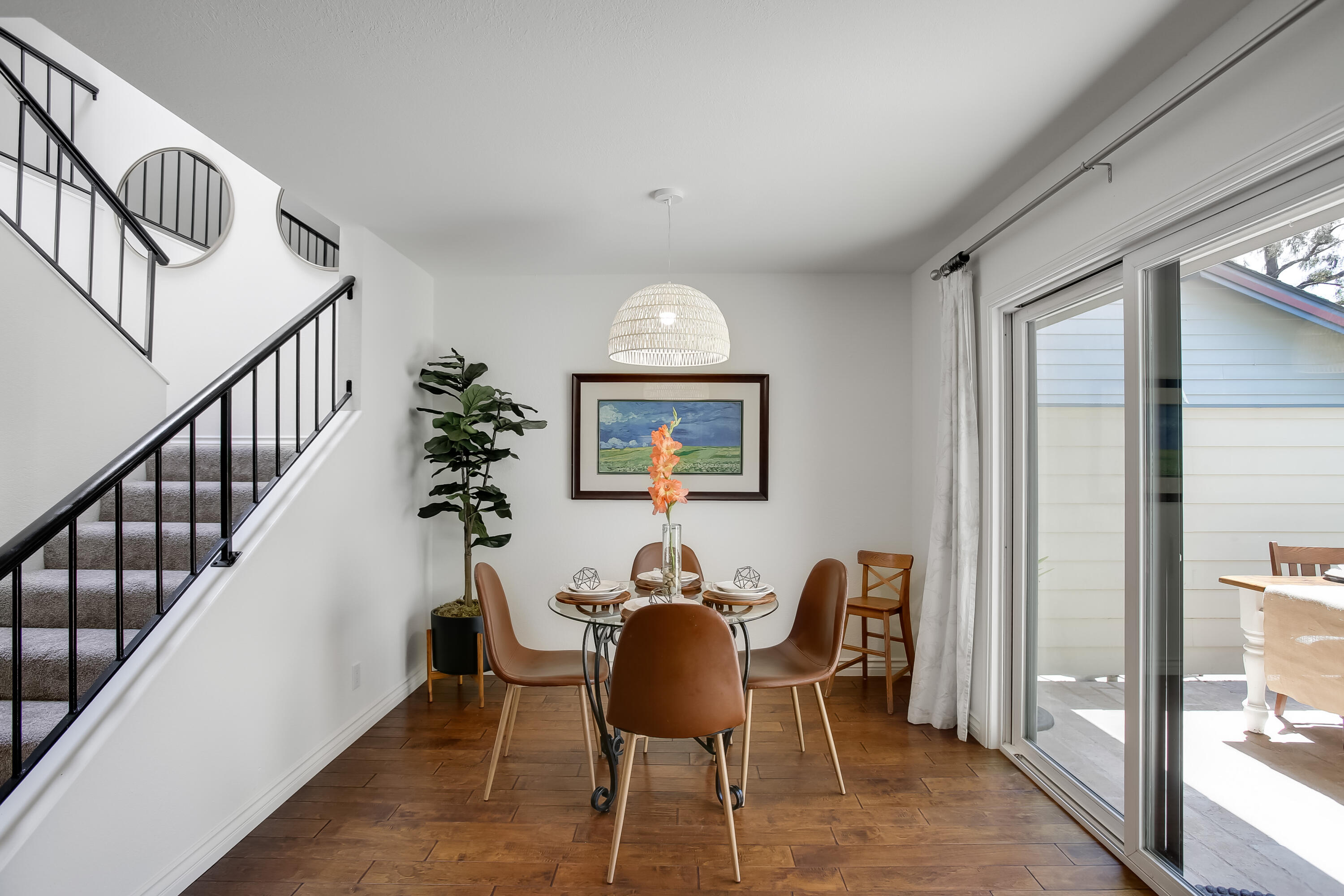 5341 Traci Drive Santa Barbara, CA 93111 - Photo 11 of 23 a dining room with furniture potted plants and wooden floor