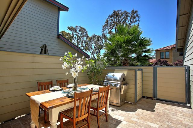 a backyard of a house with table and chairs