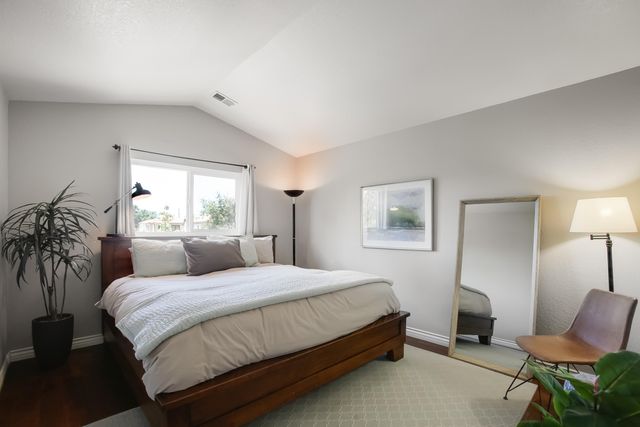 a bedroom with a bed and a chair