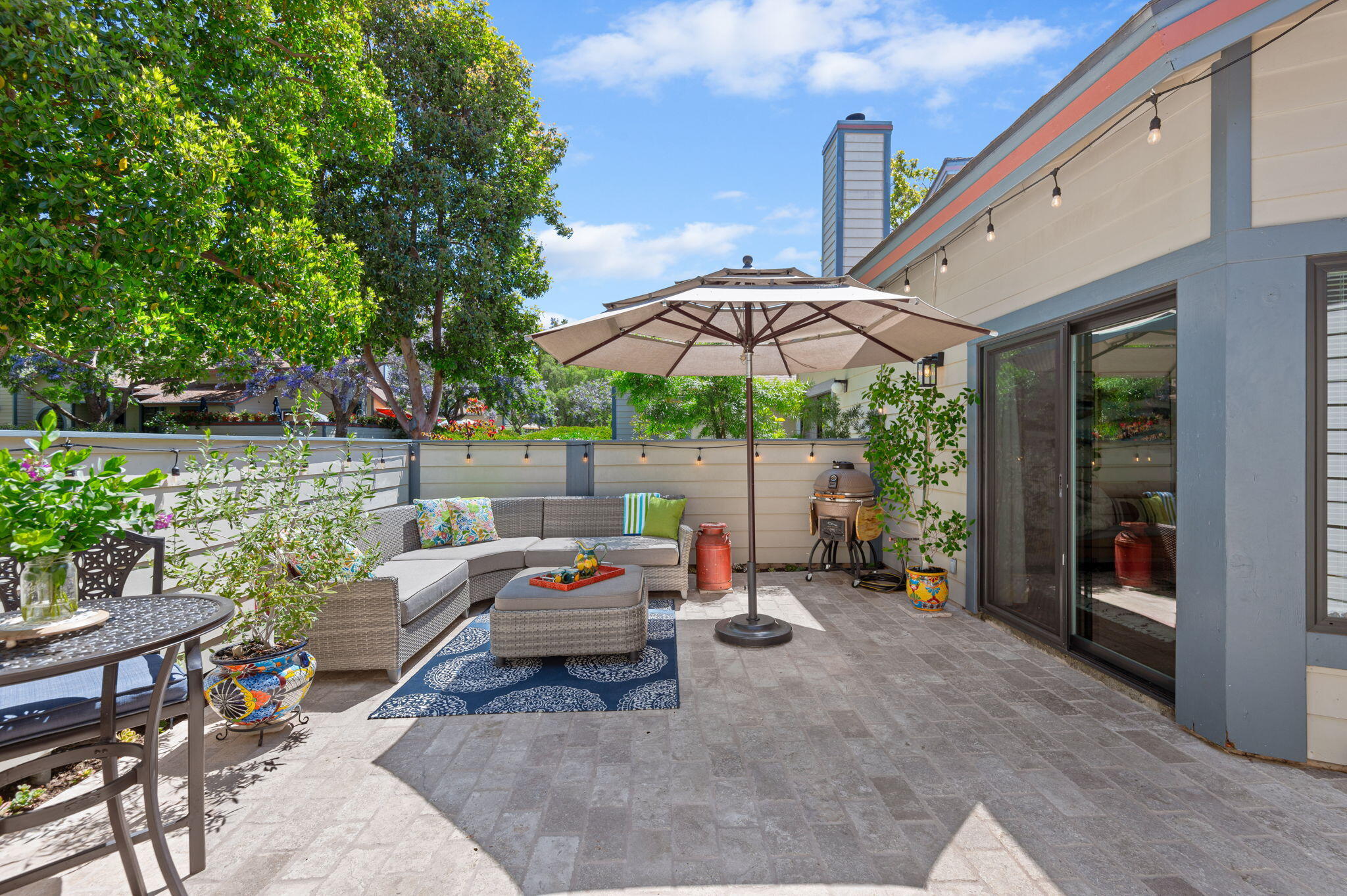 5341 Traci Drive Santa Barbara, CA 93111 - Photo 22 of 23 a patio with patio a table and chairs under an umbrella
