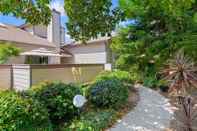 a view of a house with a yard and plants