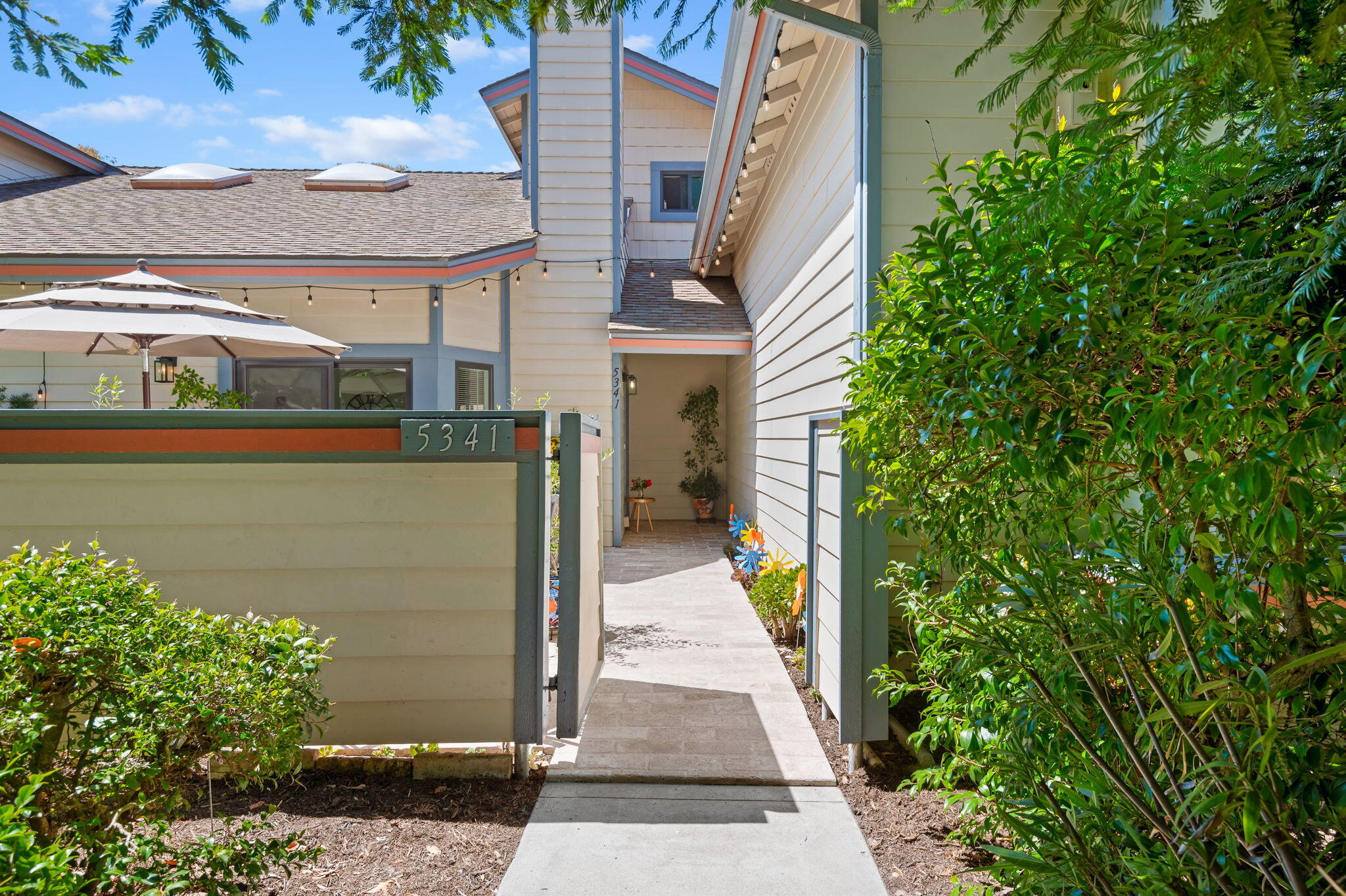 5341 Traci Drive Santa Barbara, CA 93111 - Photo 4 of 23 a picture of a brick house with a small yard plants and large tree