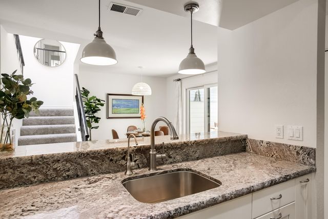 a kitchen with a sink and a chandelier