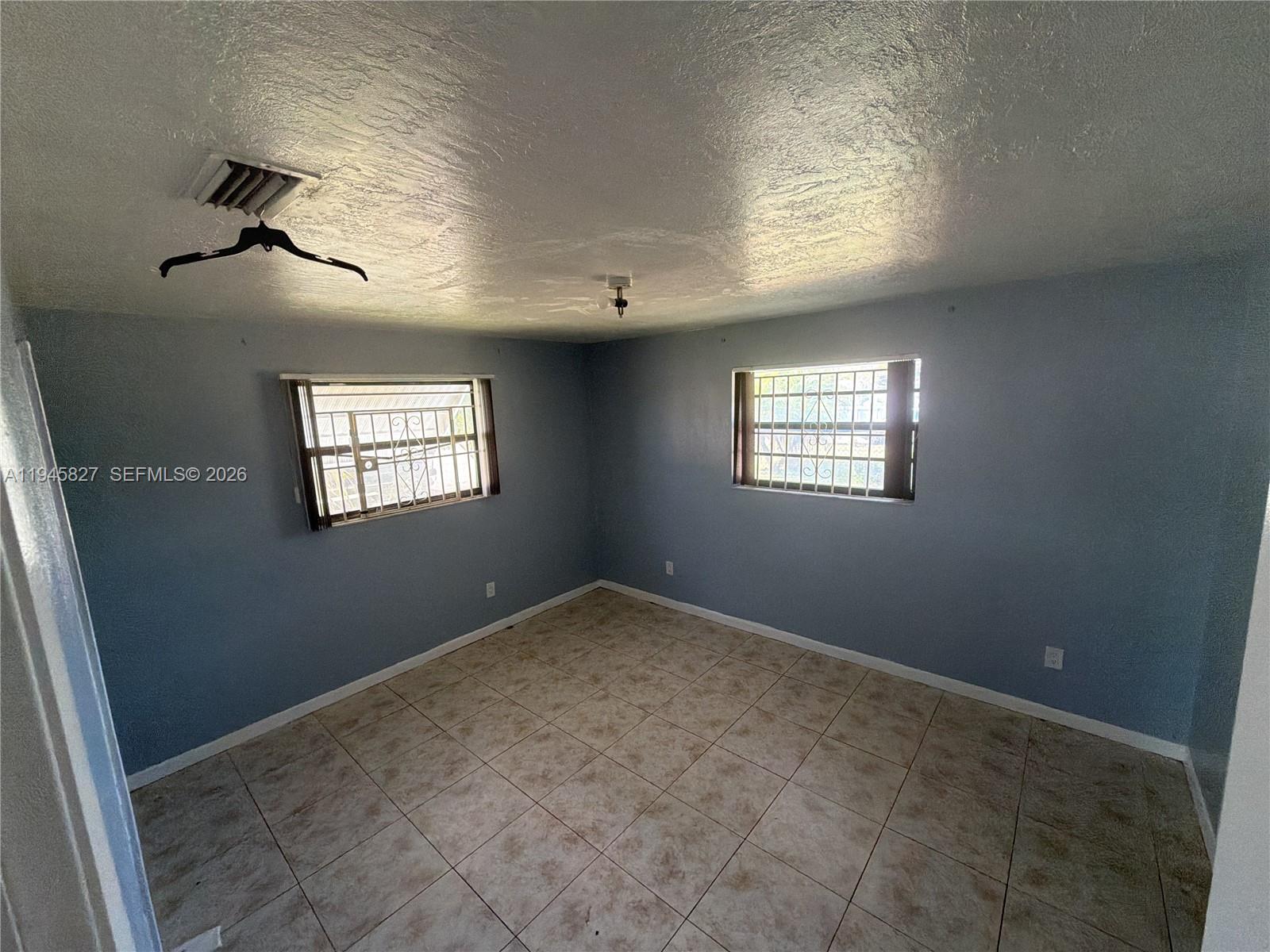 22192 Southwest 117th Avenue, Unit 1 Miami, FL 33170 - Photo 2 of 6 a view of an empty room and window