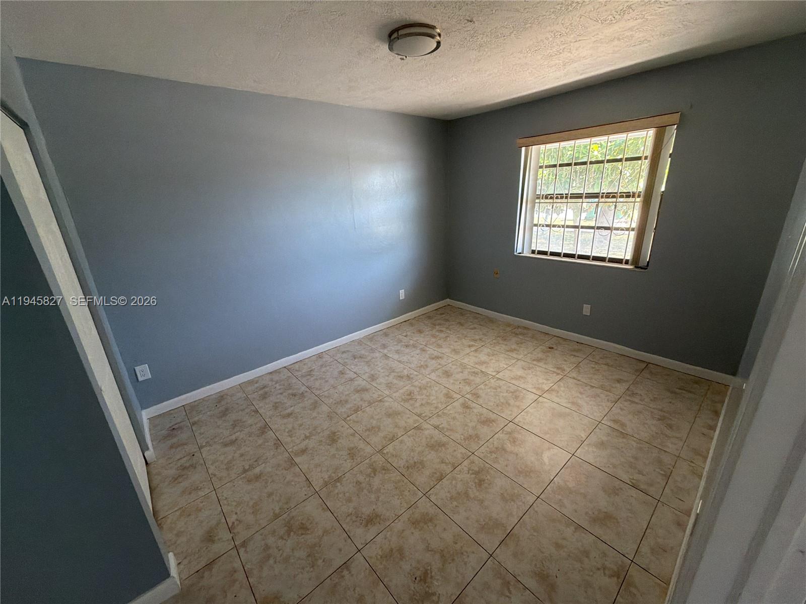 22192 Southwest 117th Avenue, Unit 1 Miami, FL 33170 - Photo 5 of 6 an empty room with windows