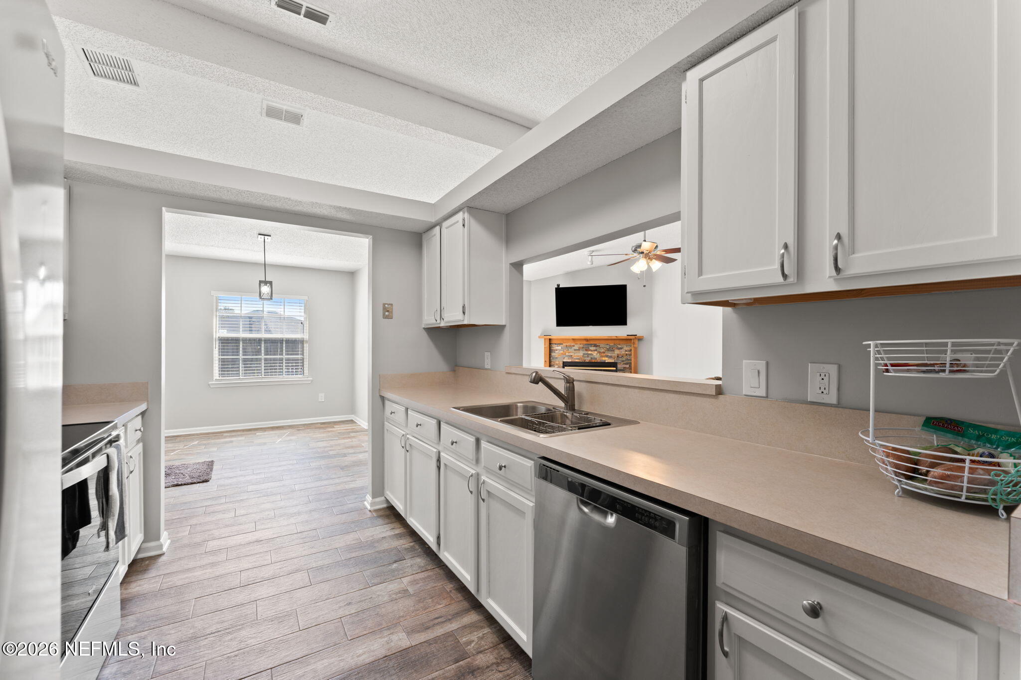2982 Chief Ridaught Trail Middleburg, FL 32068 - Photo 6 of 29 a kitchen with stainless steel appliances granite countertop a sink stove and cabinets