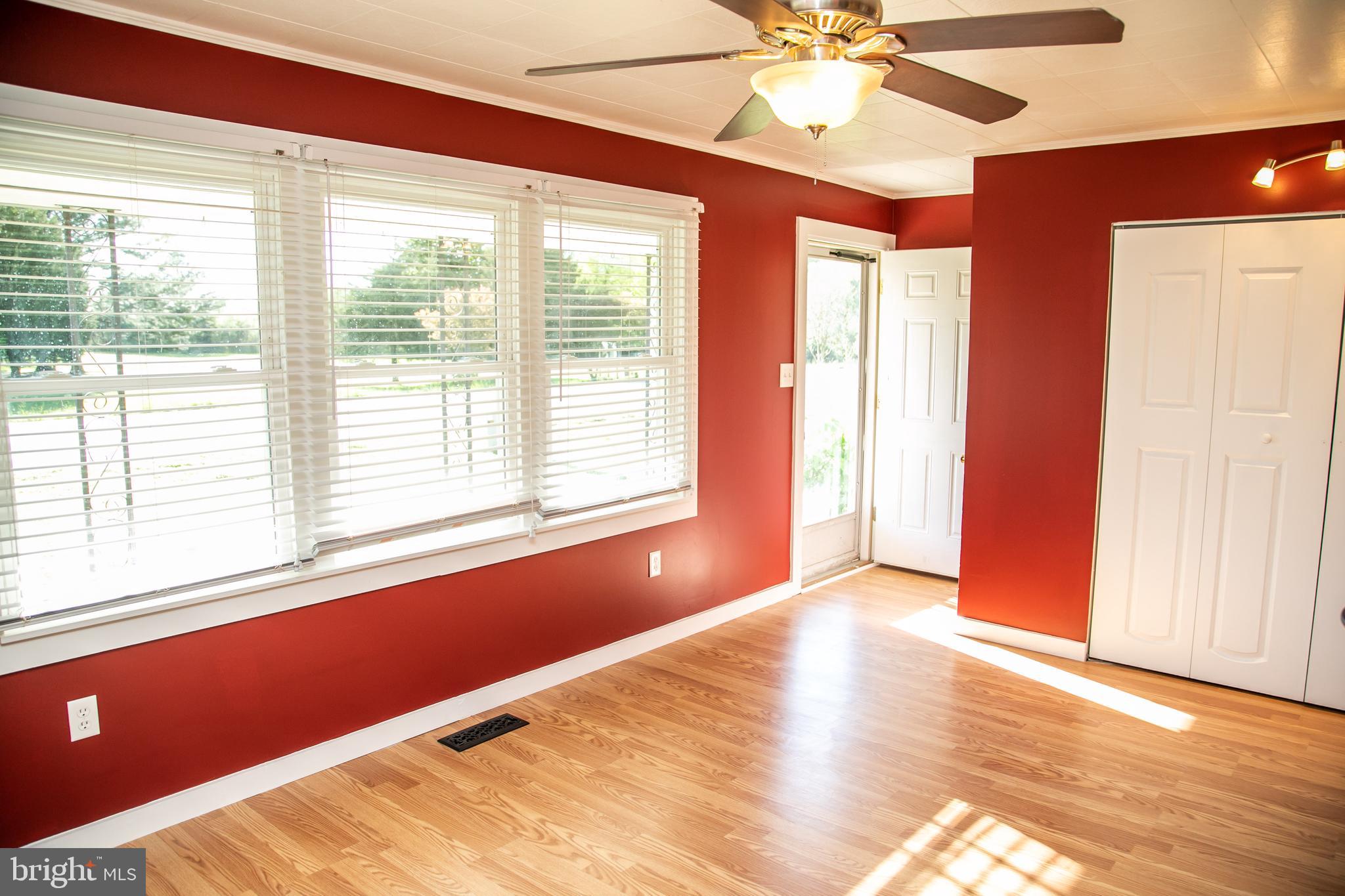 20135 Nanticoke Road Nanticoke, MD 21840 - Photo 19 of 47 a view of an empty room with a window and wooden floor