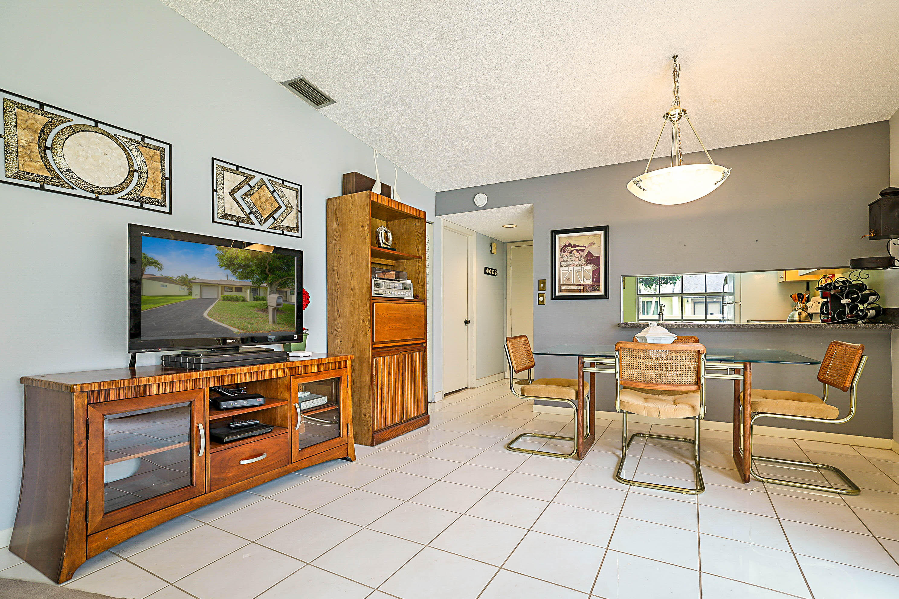 5231 Copperleaf Circle Delray Beach, FL 33484 - Photo 7 of 31 a living room with furniture and a flat screen tv
