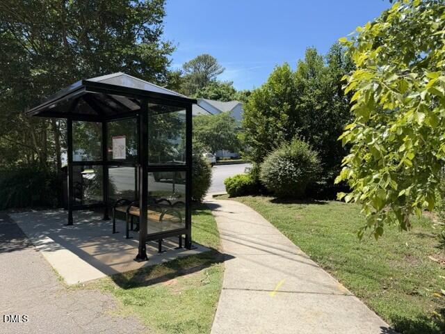 2506 Avent Ferry Road, Unit 101 Raleigh, NC 27606 - Photo 8 of 19 a view of backyard with table and chairs under an umbrella
