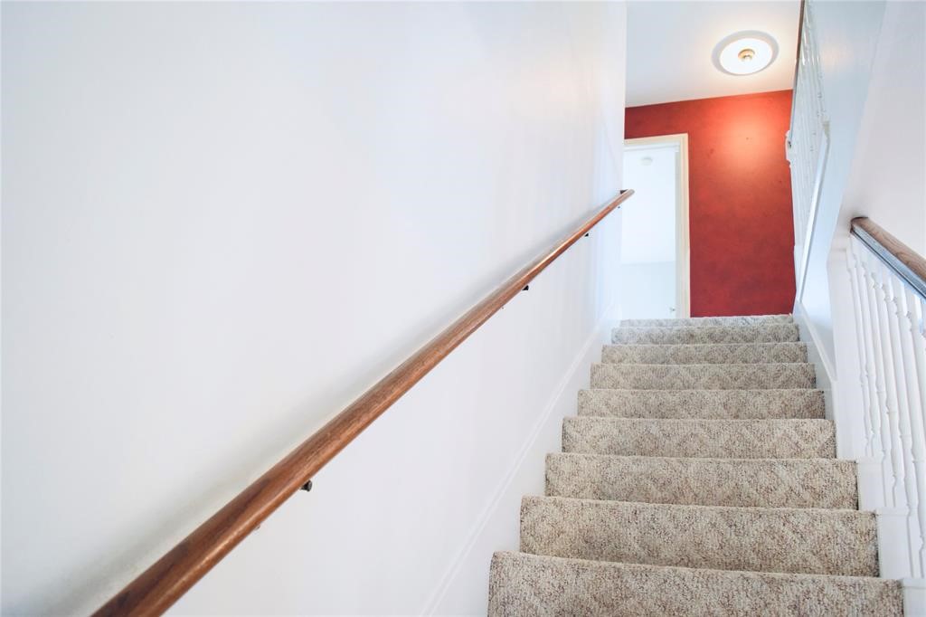 4722 Woodside Street Houston, TX 77023 - Photo 12 of 24 a view of staircase with white walls