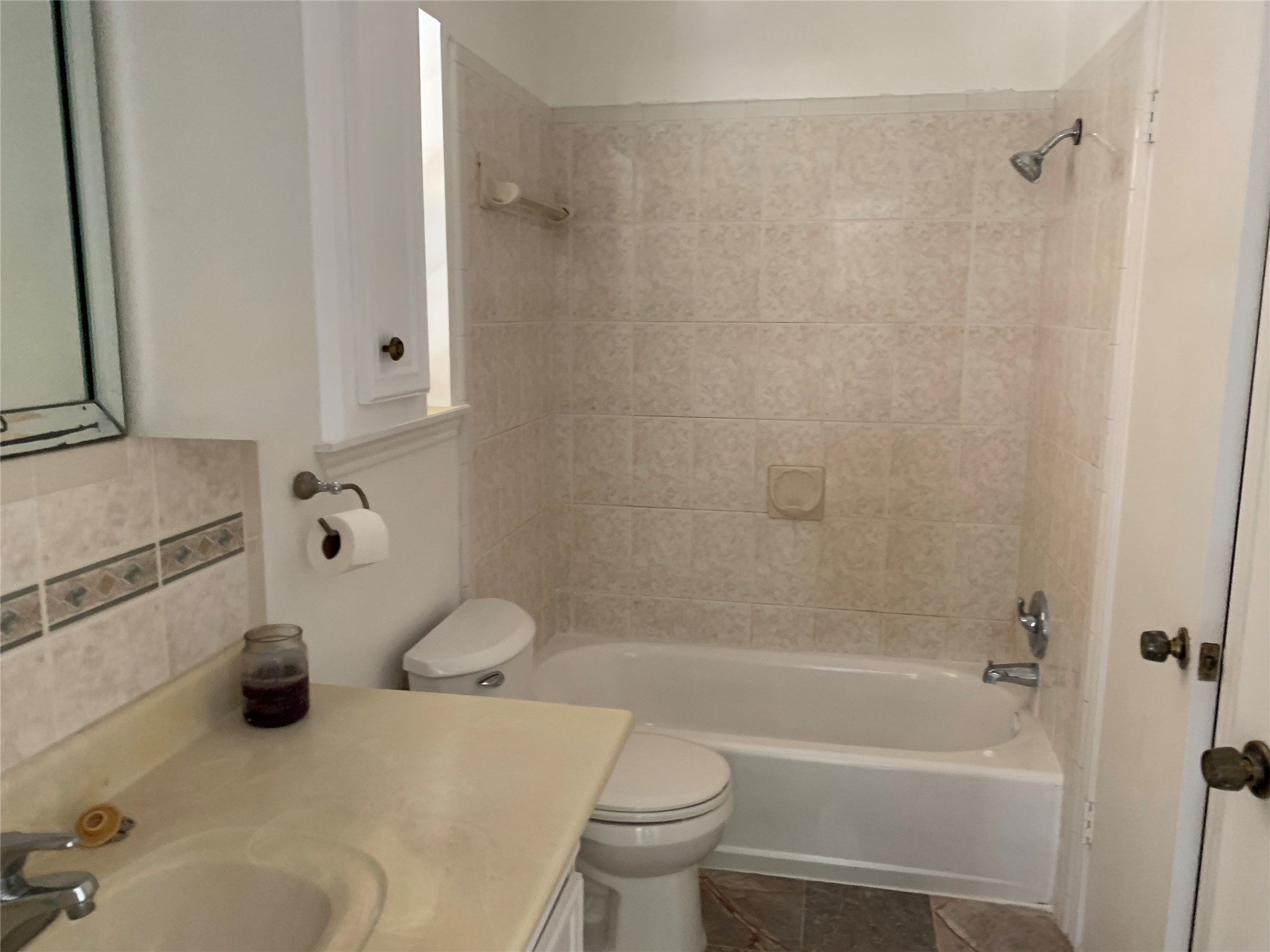 4722 Woodside Street Houston, TX 77023 - Photo 16 of 24 a bath room with a toilet and a bath tub