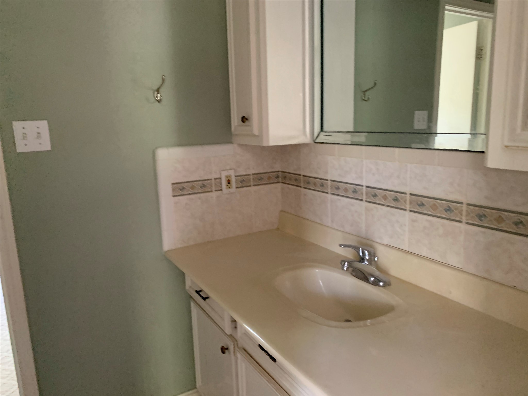 4722 Woodside Street Houston, TX 77023 - Photo 17 of 24 a bathroom with a sink and mirror