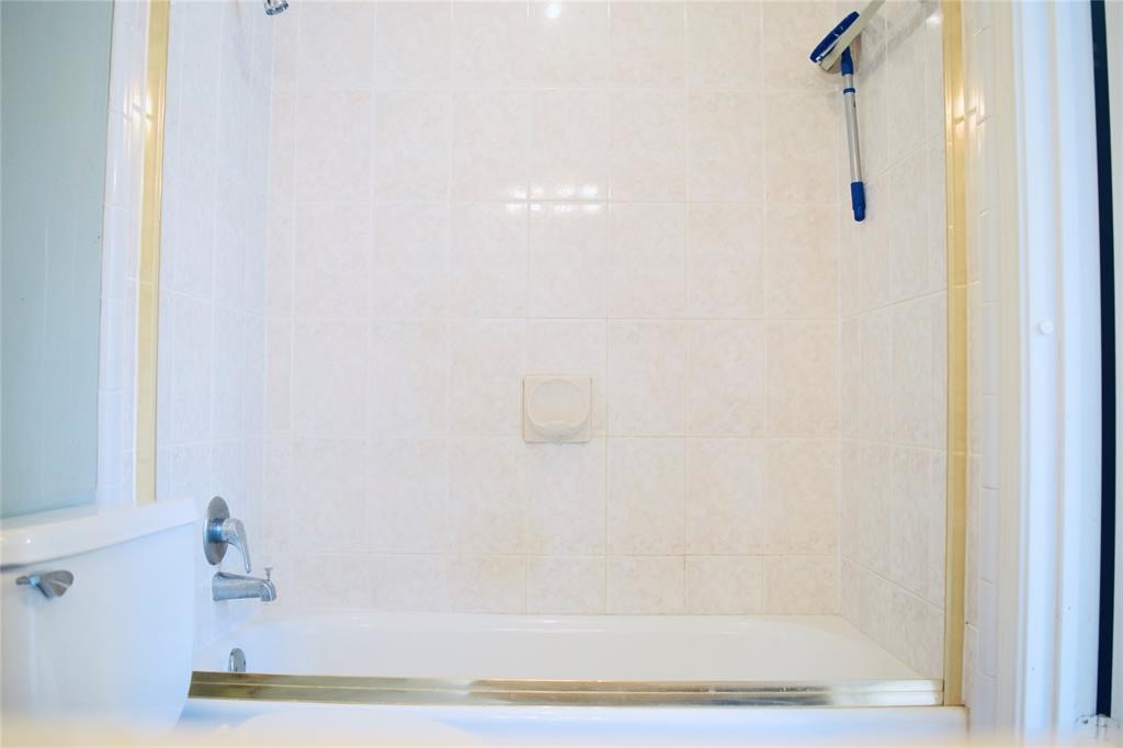 4722 Woodside Street Houston, TX 77023 - Photo 18 of 24 a bathroom with a shower