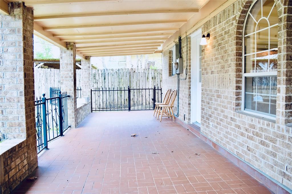 4722 Woodside Street Houston, TX 77023 - Photo 23 of 24 a view of a porch with a floor to ceiling window