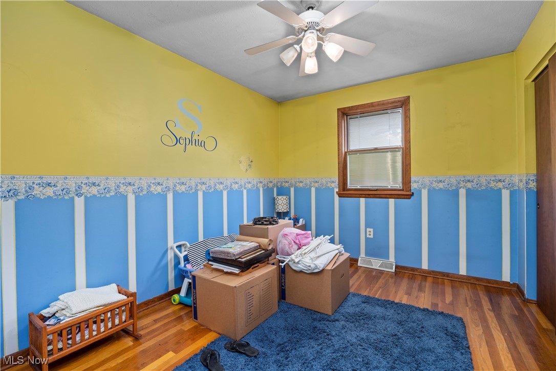 11811 Robson Road Grafton, OH 44044 - Photo 25 of 50 Misc room featuring wood finished floors, ceiling fan, and wainscoting
