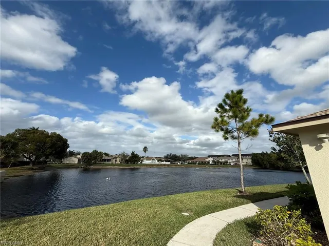 a view of a lake with houses in the back