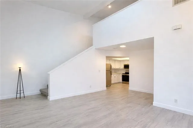 a view of a room with wooden floor