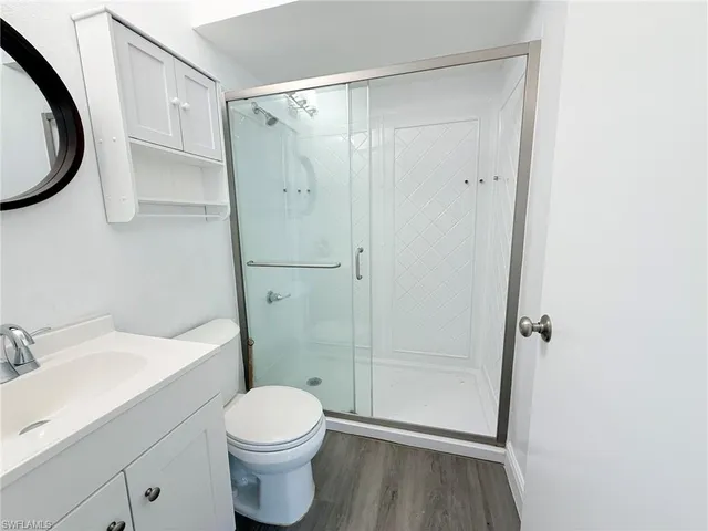 a bathroom with a toilet a sink and shower