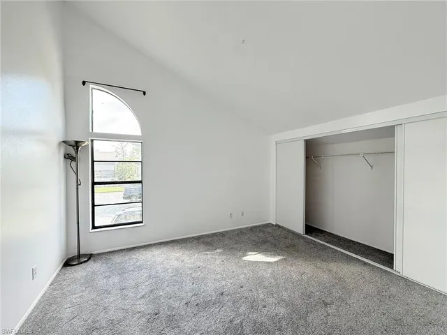 an empty room with windows and closet