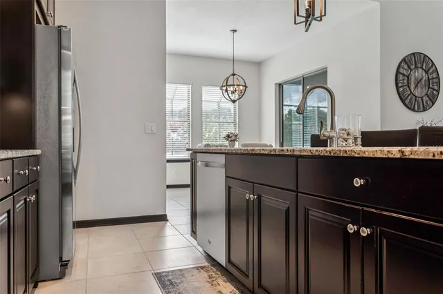 a living room with furniture a flat screen tv and a wall clock