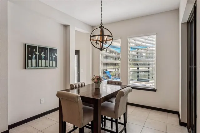 a living room with furniture kitchen area and a wooden floor