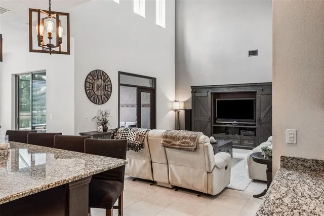 a living room with furniture a window and a flat screen tv