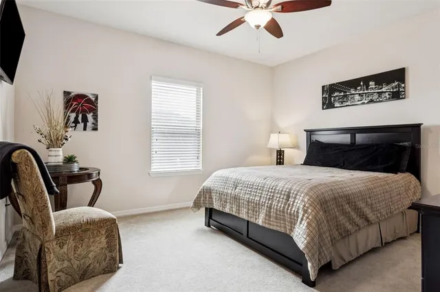 a bedroom with a bed and a large window