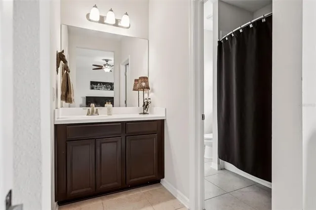 a spacious bathroom with a tub sink and mirror