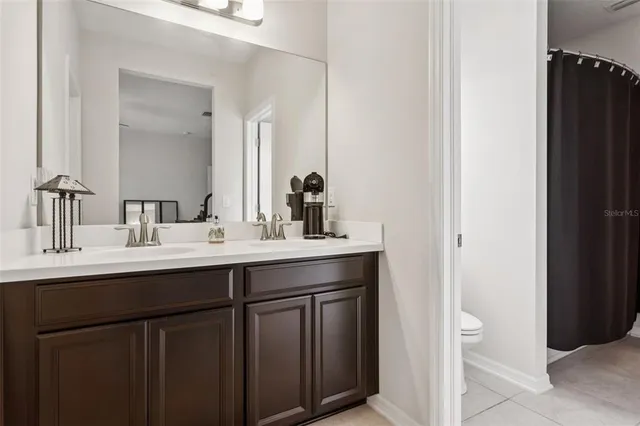 a bathroom with a tub sink and mirror