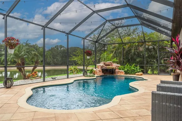 a view of house with garden space and lake view