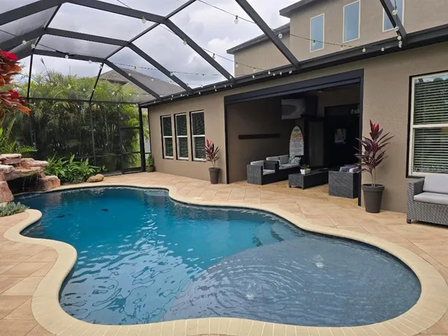 a front view of a house with garden yard and swimming pool