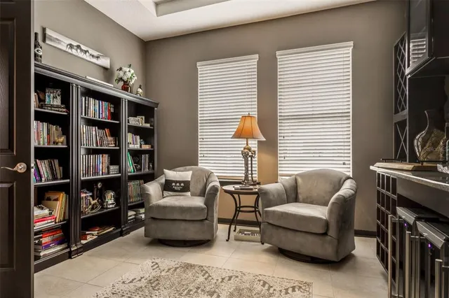 a kitchen with stainless steel appliances granite countertop a refrigerator a stove a sink a dining table and chairs