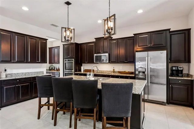 a dining room with furniture a chandelier and window