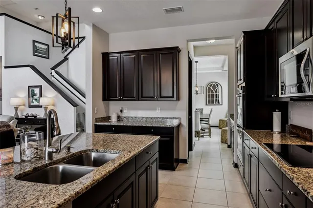 a view of a dining room with furniture a chandelier and wooden floor