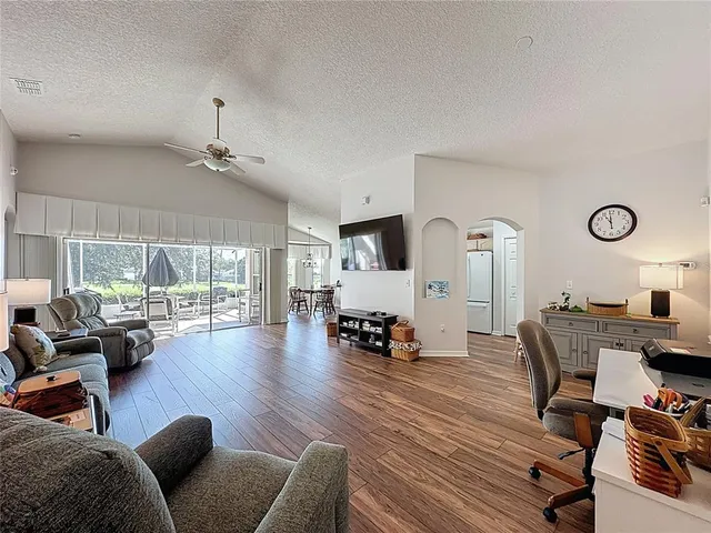 a living room with furniture and a wooden floor