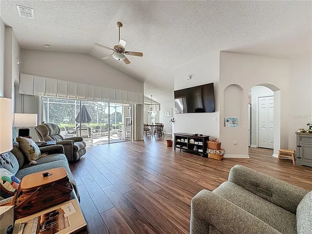 a kitchen with a sink stove cabinets and wooden floor