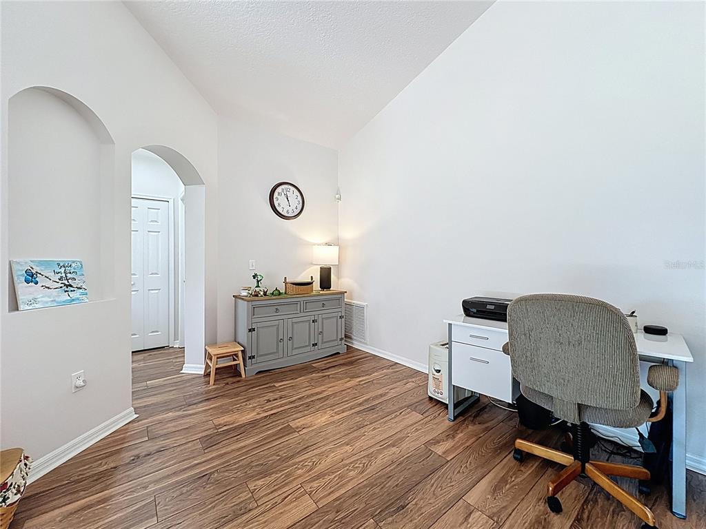 2292 Edmonton Court Clermont, FL 34711 - Photo 15 of 76 a view of a workspace with furniture and wooden floor