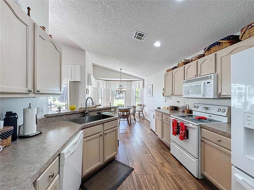 2292 Edmonton Court Clermont, FL 34711 - Photo 22 of 76 a kitchen with granite countertop lots of counter top space a sink and appliances