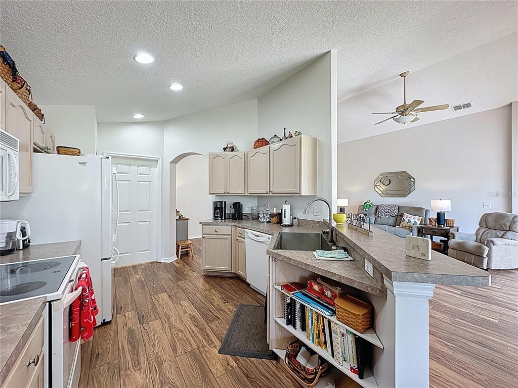 2292 Edmonton Court Clermont, FL 34711 - Photo 25 of 76 a open kitchen with stainless steel appliances granite countertop a stove and cabinets