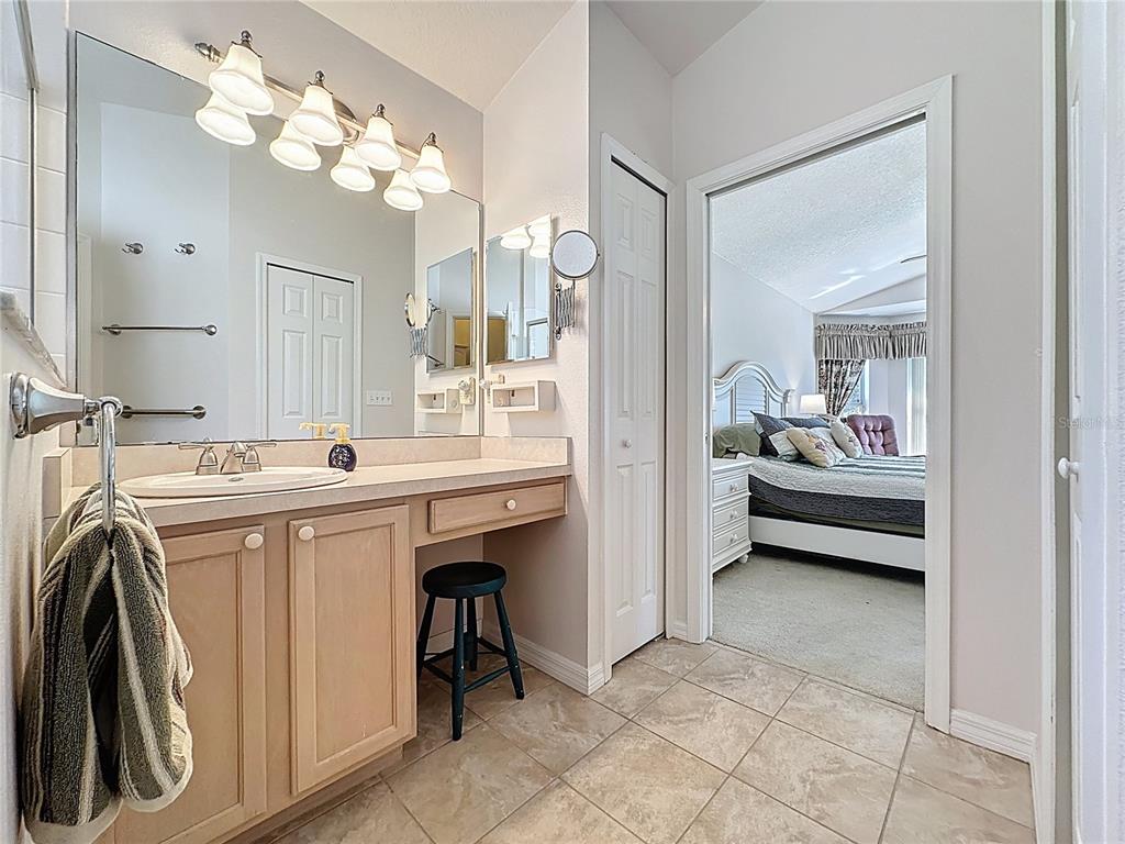 2292 Edmonton Court Clermont, FL 34711 - Photo 30 of 76 a en suite bathroom with a double vanity sink and a mirror