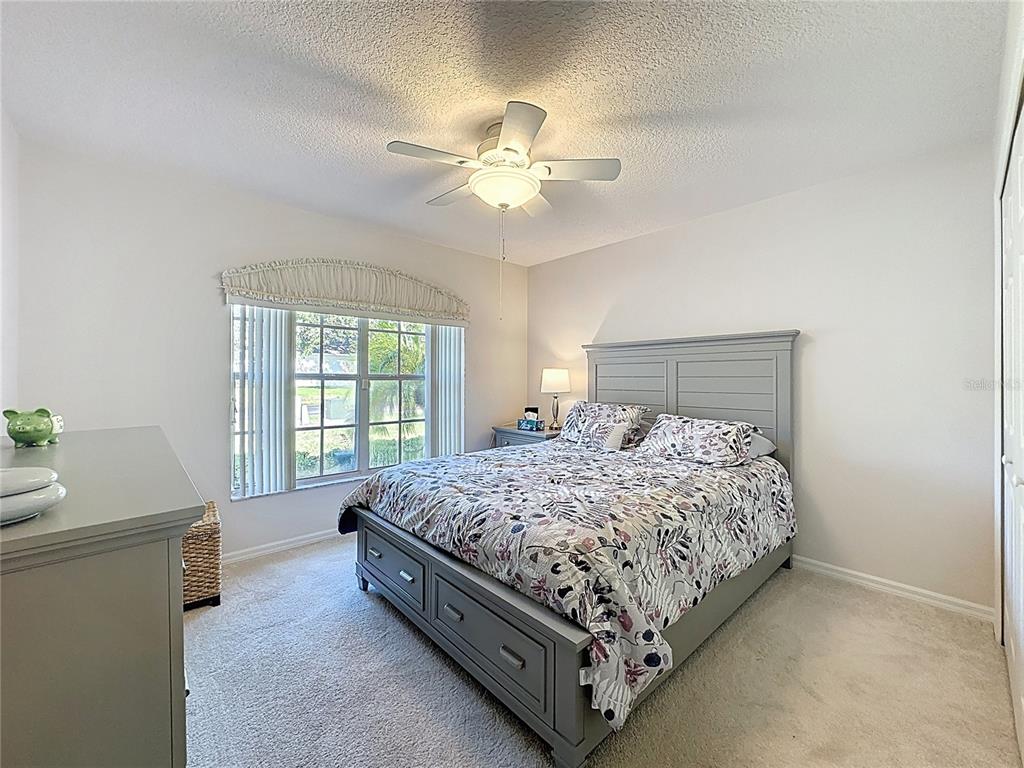 2292 Edmonton Court Clermont, FL 34711 - Photo 33 of 76 a bed sitting in a bedroom next to a window