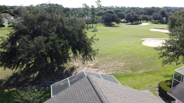 a room with stainless steel appliances kitchen island a table and chairs in it