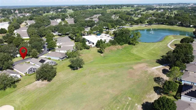an aerial view of residential houses with outdoor space and lake view