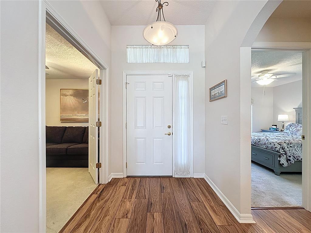 2292 Edmonton Court Clermont, FL 34711 - Photo 8 of 76 a view of livingroom with hardwood floor and a hallway