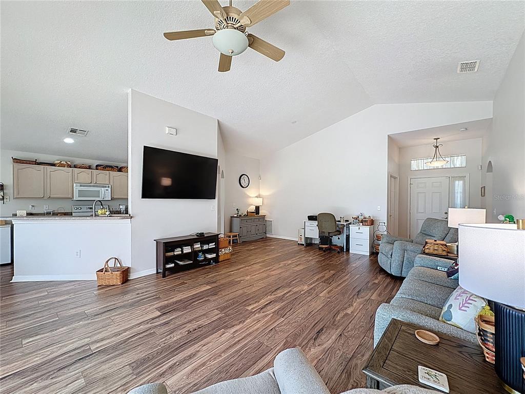 2292 Edmonton Court Clermont, FL 34711 - Photo 9 of 76 a living room with furniture and a flat screen tv
