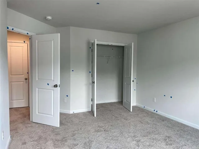 an empty room with closet area